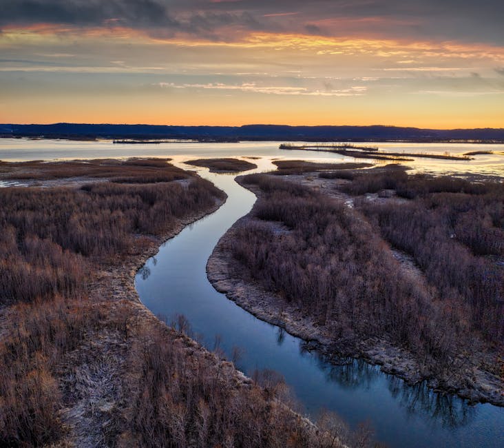 Stunning aerial view of winding river at sunset in Weaver, Minnesota, showcasing a serene natural landscape.